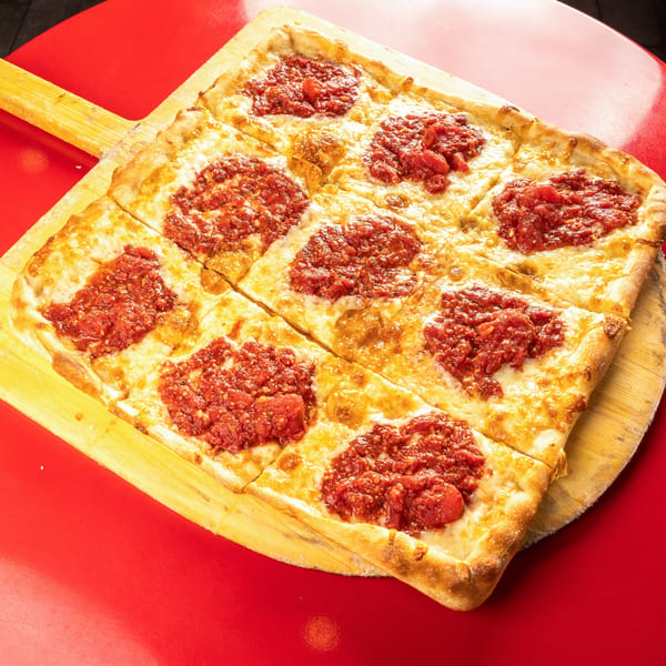 Al Forno's square pizza, cut into eight slices, with melted cheese and dollops of red sauce.